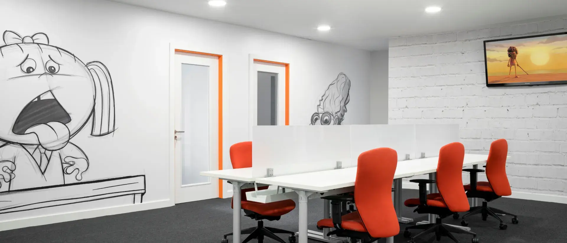 Meeting room with orange chairs, white walls, and a mural illustration.