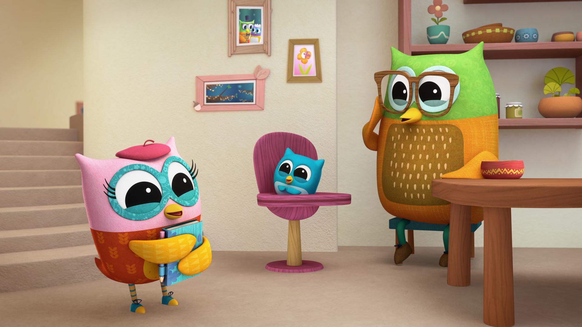 Owl characters in a warm home environment, one standing with a book, another seated in a high chair, and a third near a table with shelves in the background.