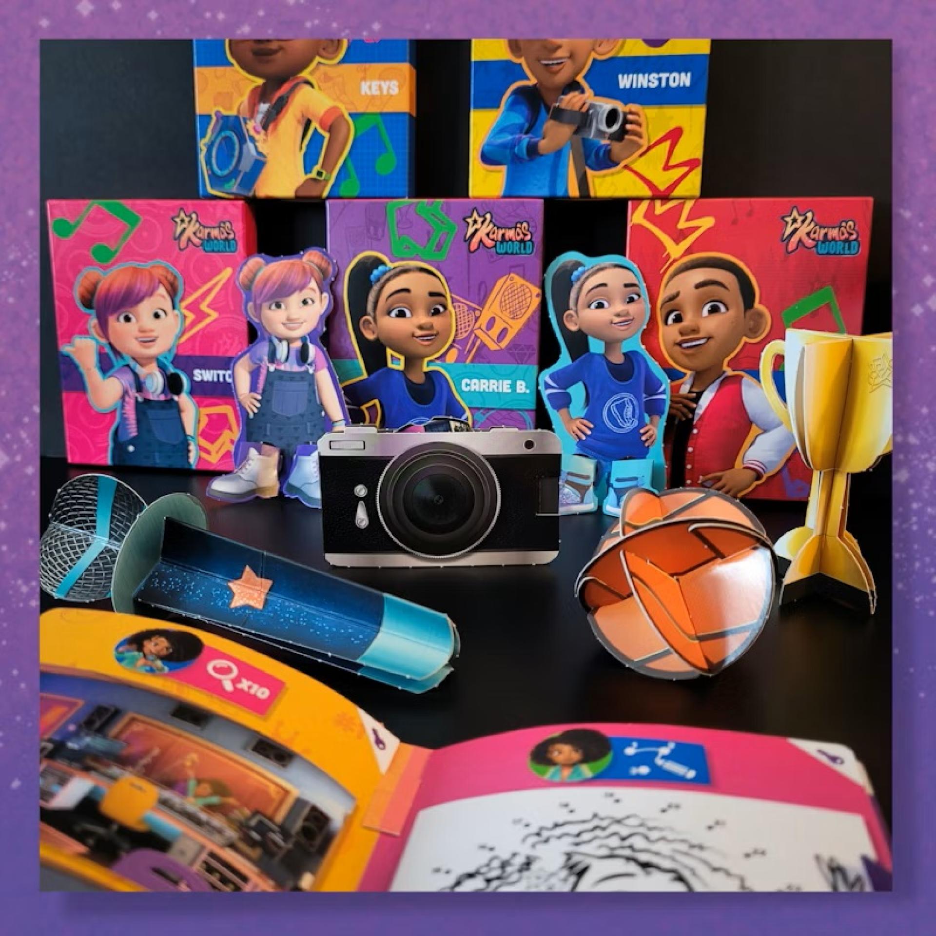 Display of Karma’s World Happy Meal toys including character cutouts, microphone, camera, trophy, basketball, and activity booklet.
