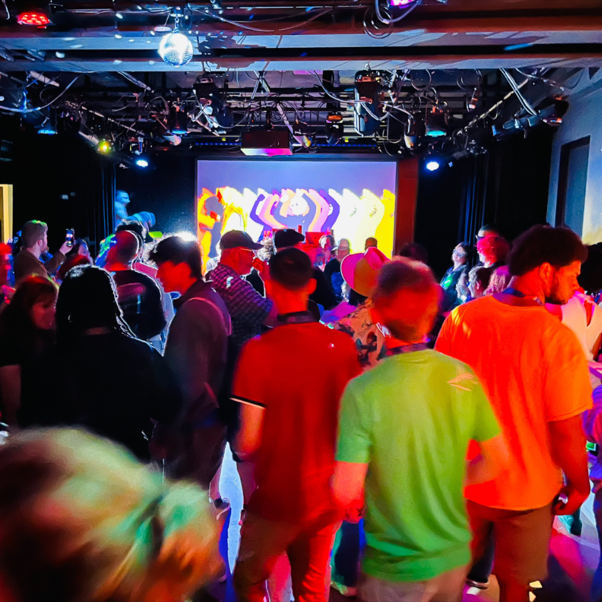 A colourfully lit room with vibrant displays at the Ottawa International Animation Festival 2023. 