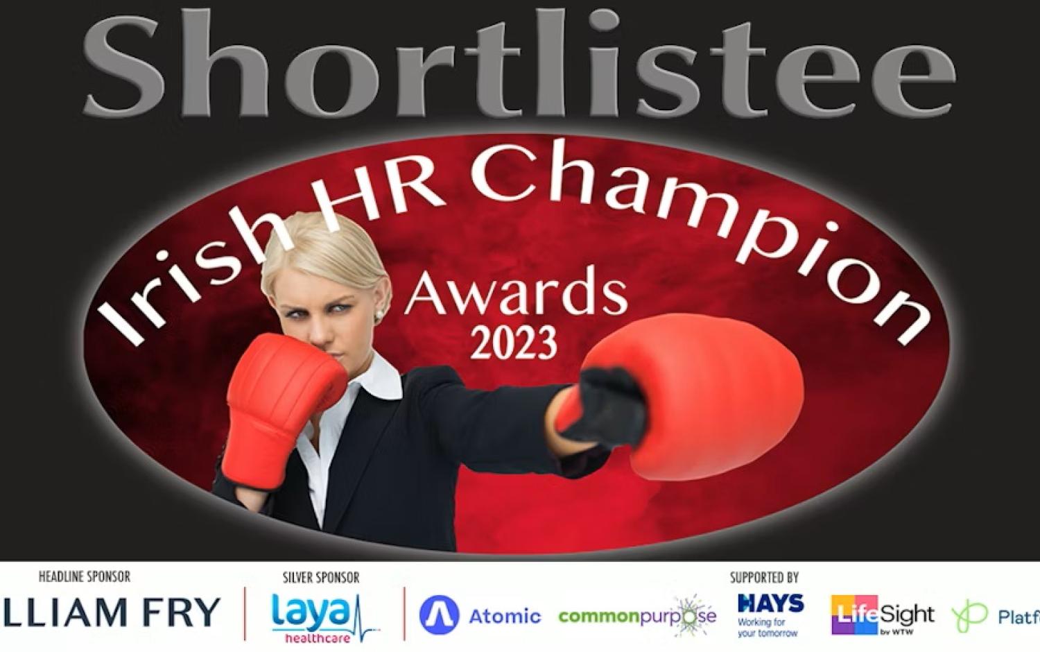 Irish HR Champion Awards 2023 shortlist graphic featuring large text “Shortlistee,” event logo on a red oval background, and sponsorship logos including William Fry, Laya Healthcare, Atomic, Common Purpose, Hays, LifeSight, and Platform55. A person wearing boxing gloves is positioned in front of the logo.