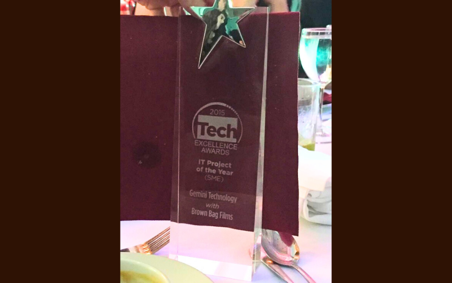 Clear acrylic award with a star on top, labeled “Tech Excellence Awards 2015 – IT Project of the Year.”