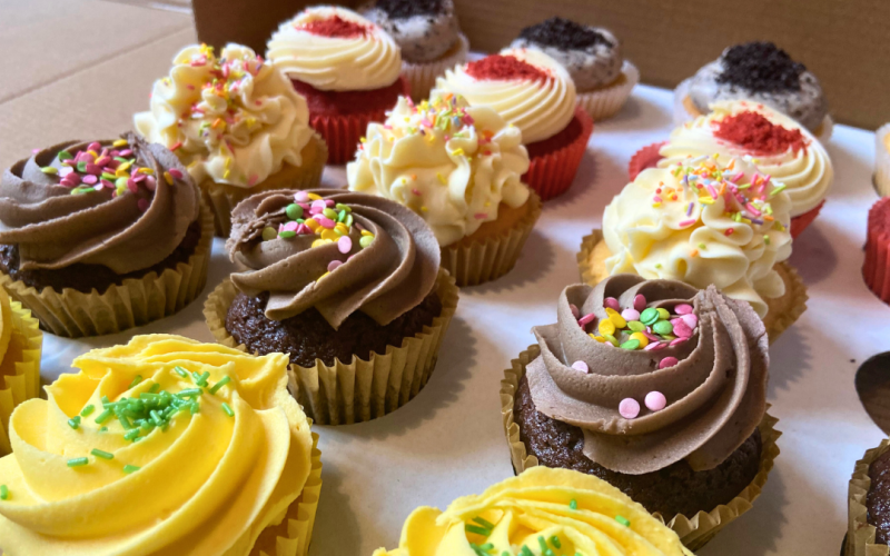 A close-up of frosted cupcakes in various flavours.