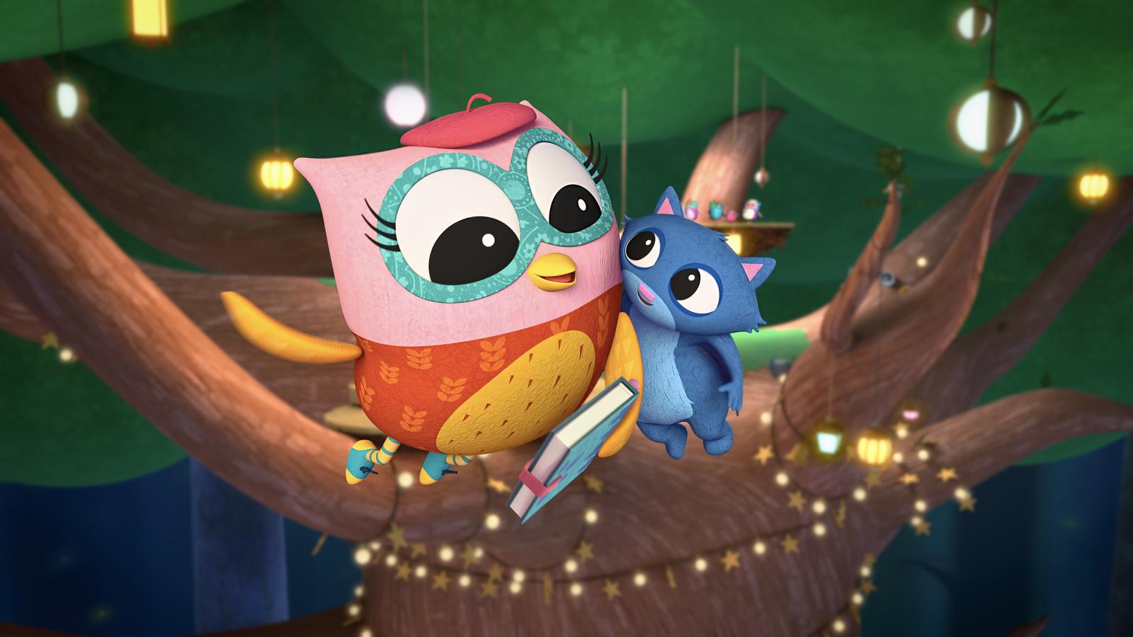 Eva the Owlet flying with her friend in front of a tree covered in fairy lights