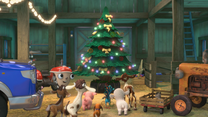 Otis and his friends around a lit up Christmas tree