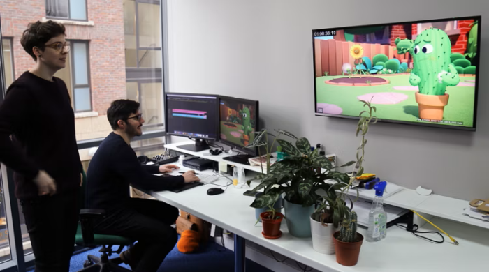 A behind-the-scenes photo of Kerrie Costello (Post Production Supervisor) and Julien Celin (Editor) working on the animated short Pins and Needles