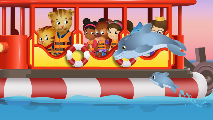 Daniel Tiger's Neighborhood: Daniel and friends ride a boat as a dolphin leaps nearby.
