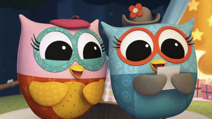 Eva the Owlet and her friend standing together. Eva's friend is holding a letter