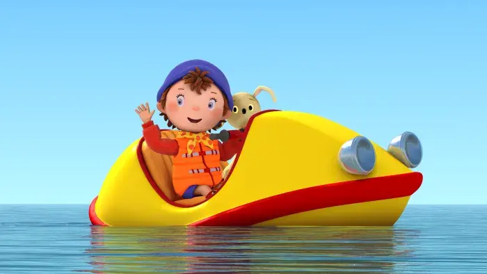 Noddy wearing a life jacket in a little boat with a dog
