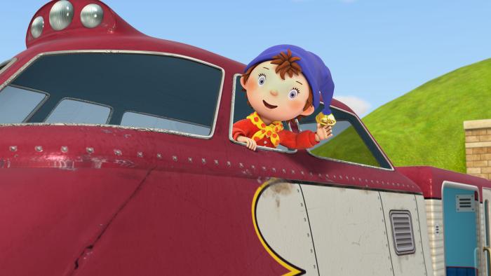 Noddy with his head out the window of a train