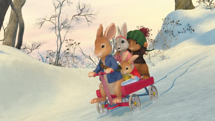 Peter, Lily and Benjamin in a cart rolling through the snow