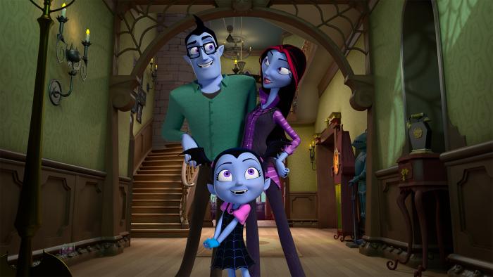 Vampirina and her family posed together in the entrance hall of their house